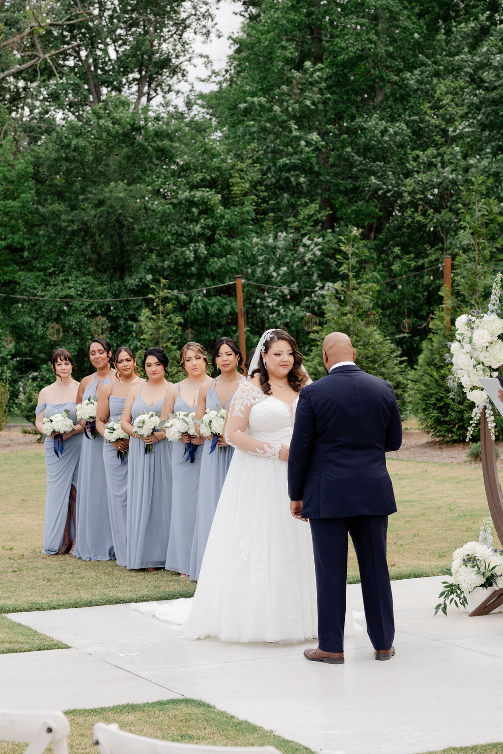 bride and groom stand hand in hand during their dreamy Georgia wedding ceremony