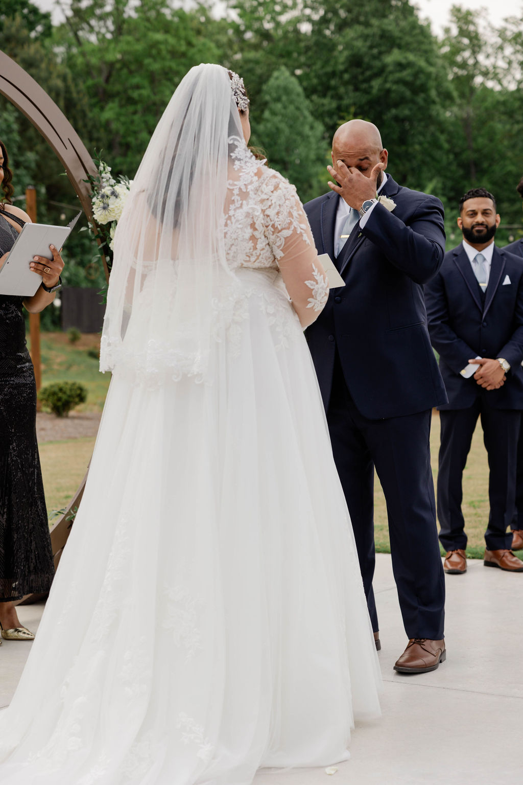 bride and groom stand hand in hand during their dreamy Georgia wedding ceremony