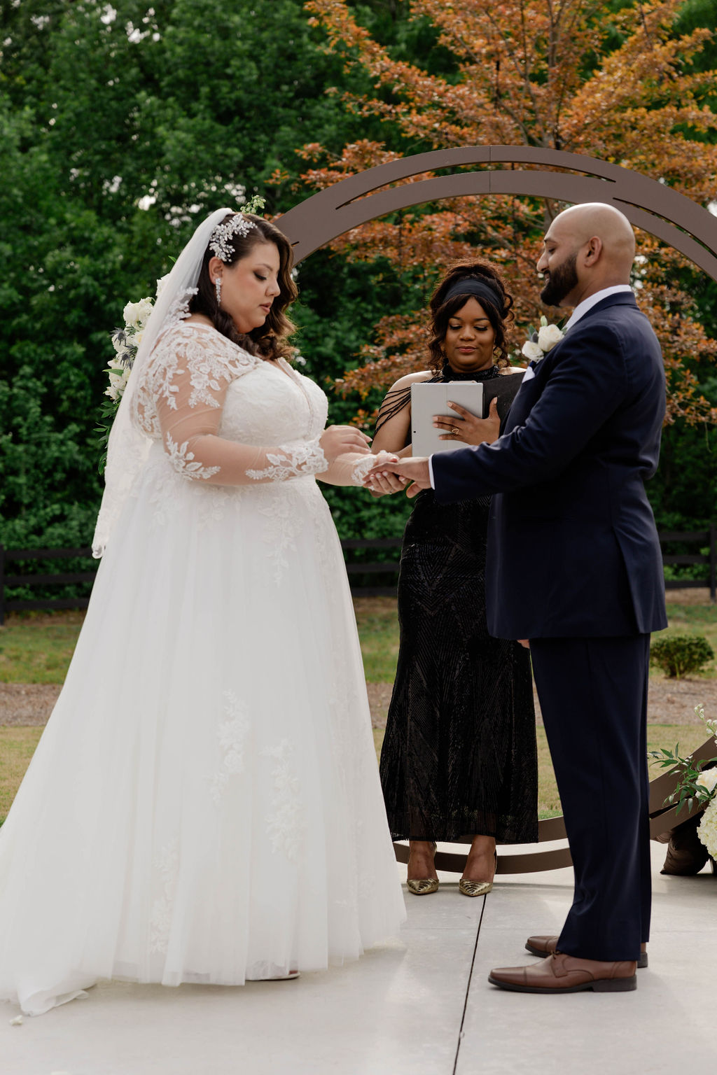 bride and groom stand hand in hand during their dreamy Georgia wedding ceremony