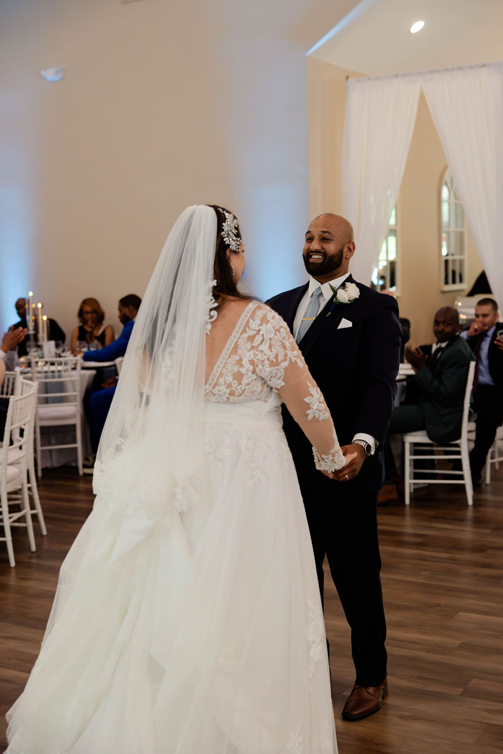 bride and groom pose during their elegant wedding reception