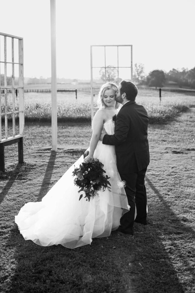 stunning bride and groom share a kiss after their dreamy wedding