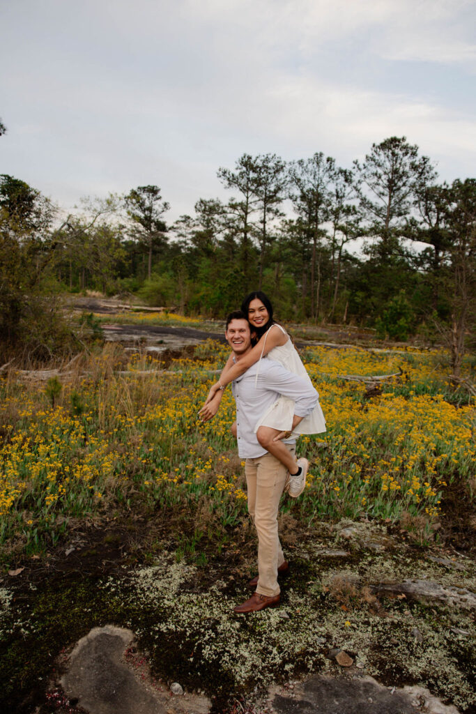 beautiful couple pose together at Arabia Mountain during their Georgia engagement photos