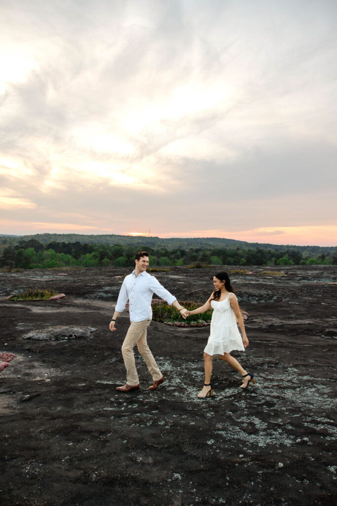 beautiful couple pose together at Arabia Mountain during their Georgia engagement photos