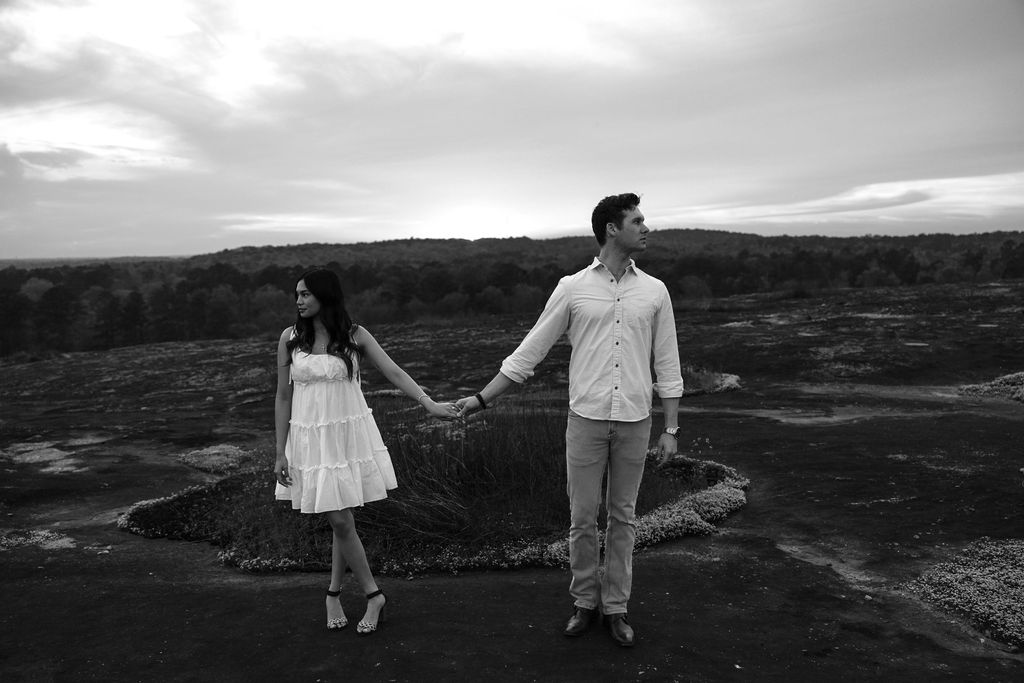 beautiful couple pose together at Arabia Mountain during their Georgia engagement photos