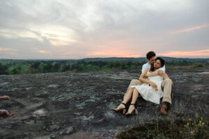 beautiful couple pose together at Arabia Mountain during their Georgia engagement photos