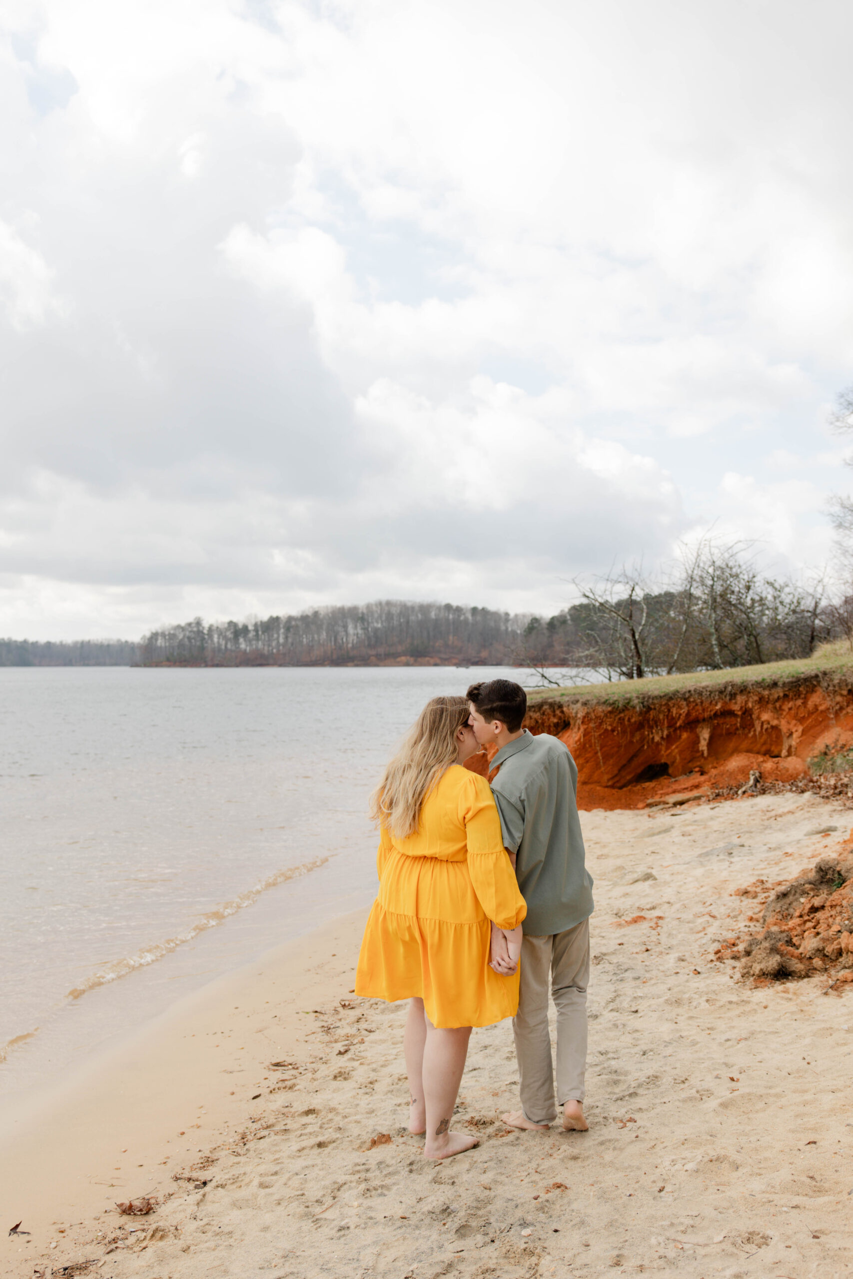 beautiful couple pose on the beach together during their engagement beach pictures