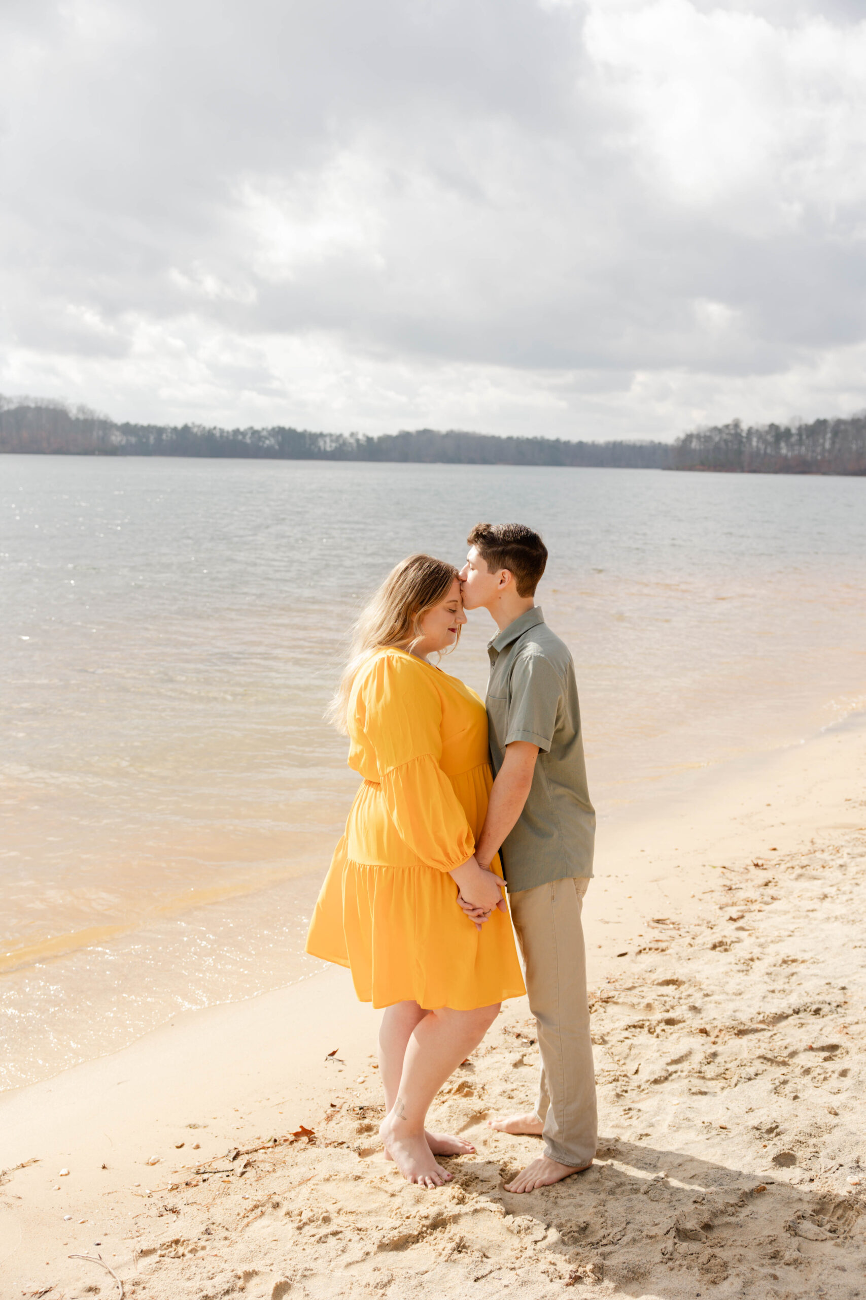beautiful couple pose on the beach together during their engagement beach pictures