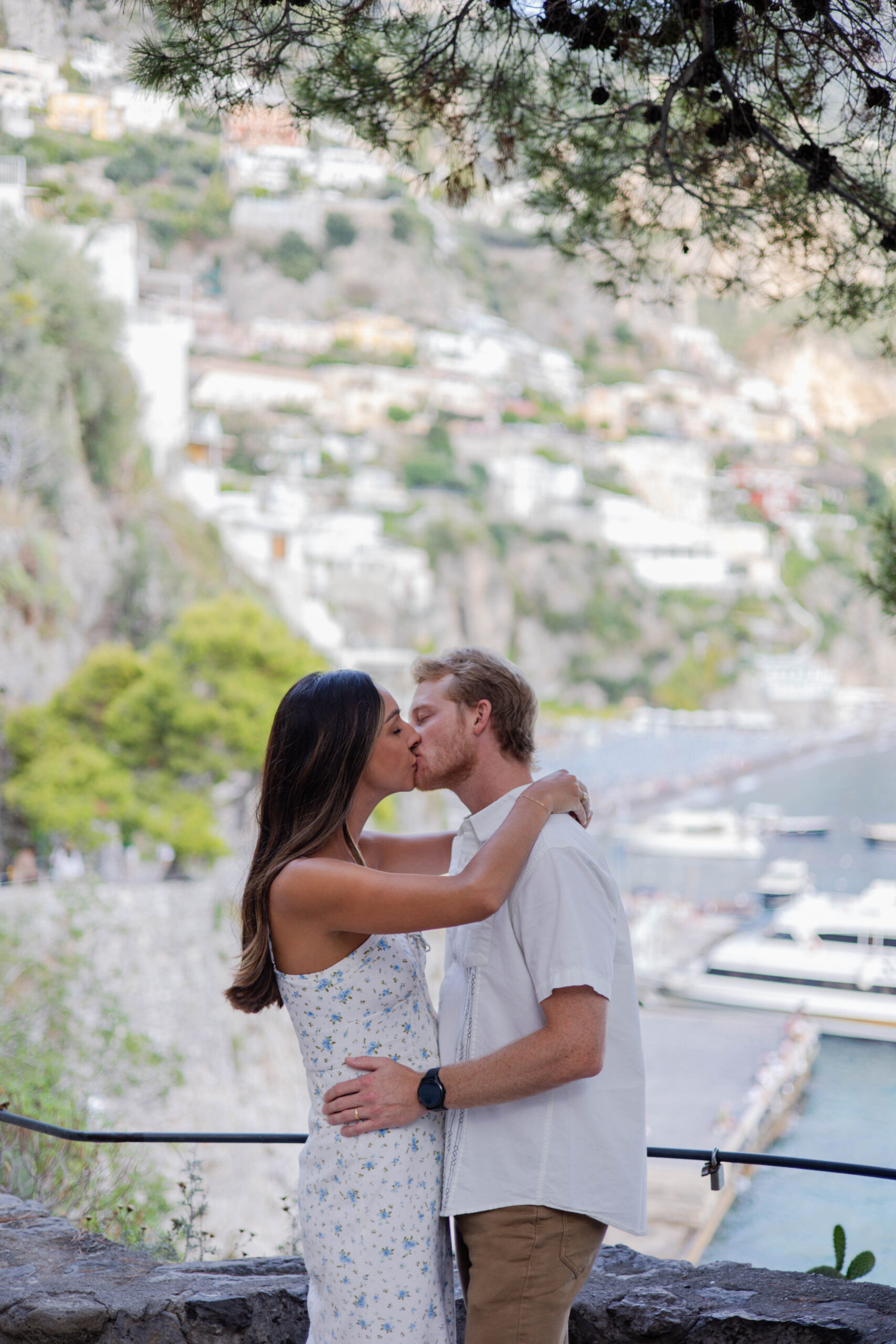 couple take an intimate photo by the water