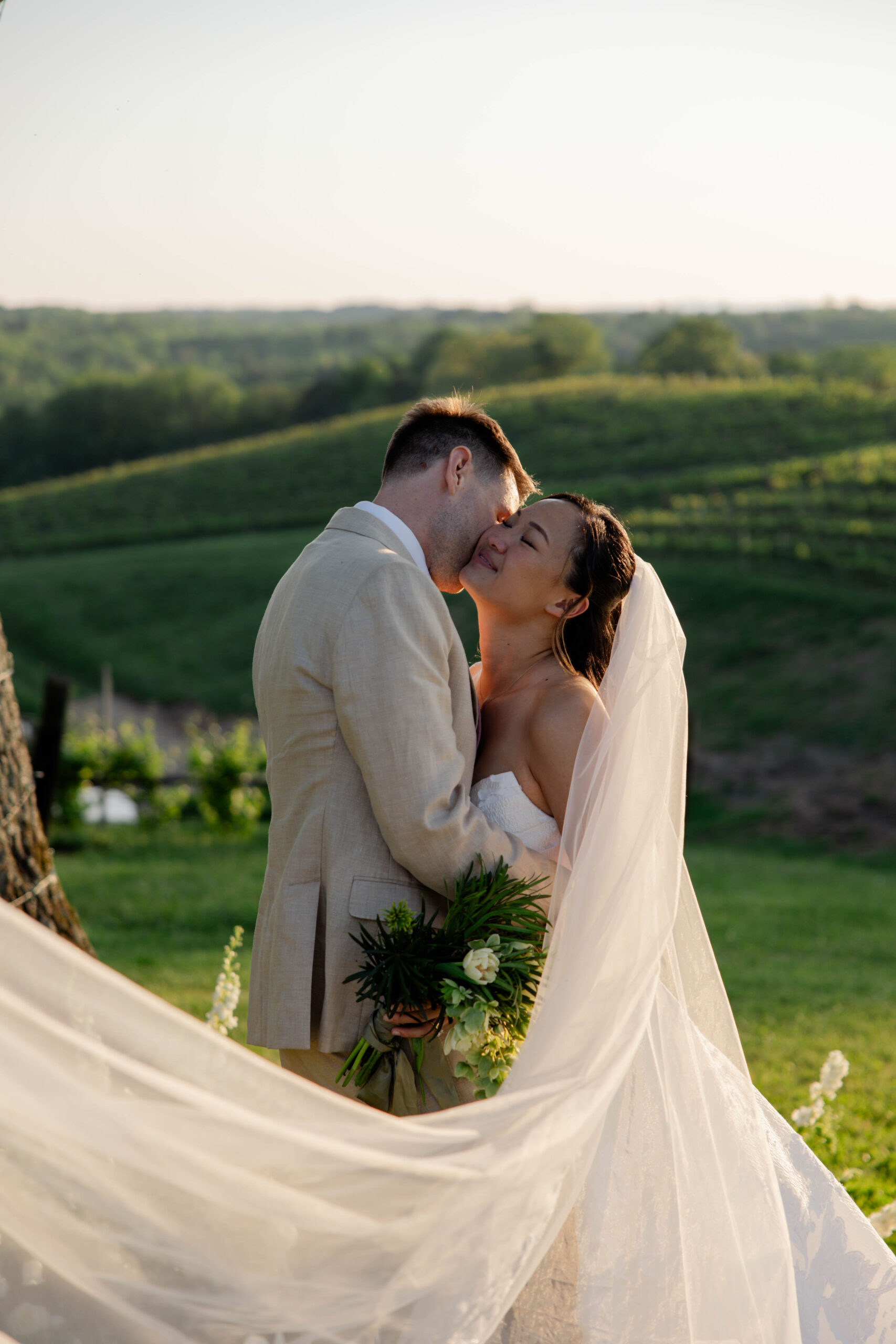 bride and groom share an intimate moment as the Italian wine country stretches behind them