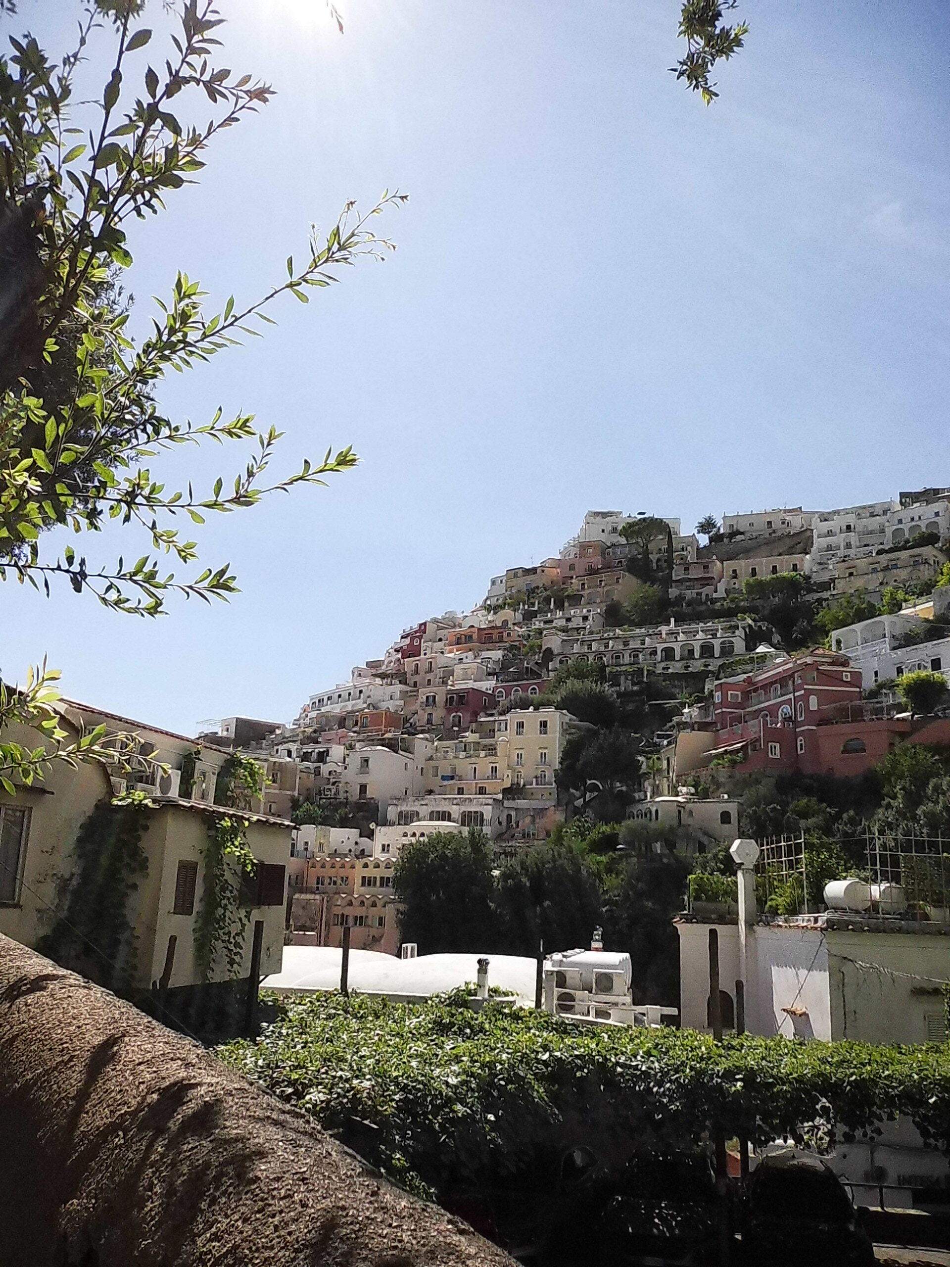 Italian mountainside village sits against the cloudless sky