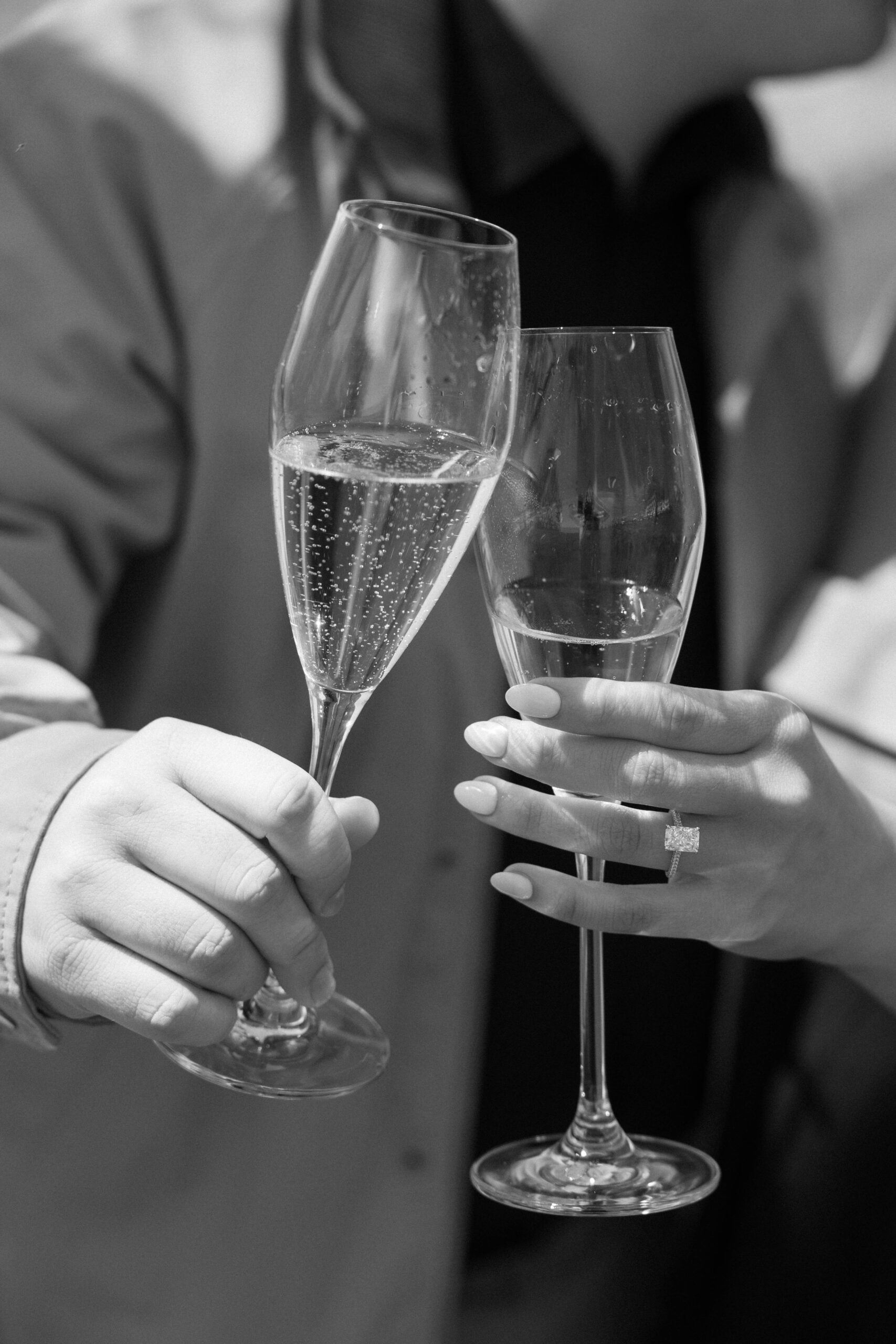 bride and groom share a toast with their champagne glasses