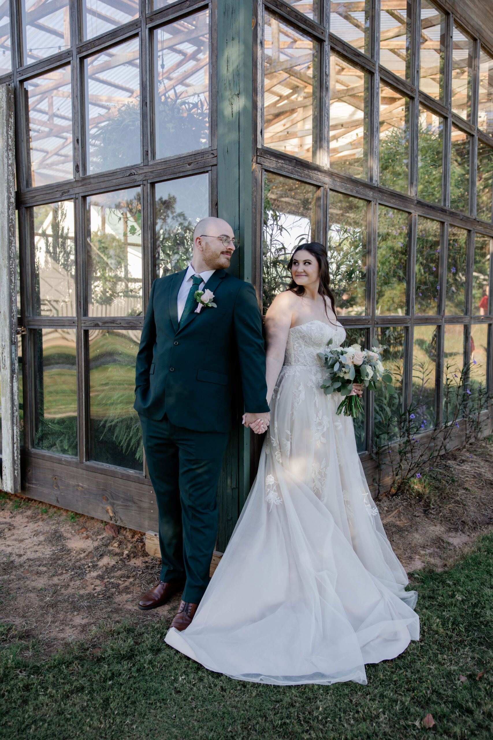 stunning bride and groom peek around the corner at each other during their first look session