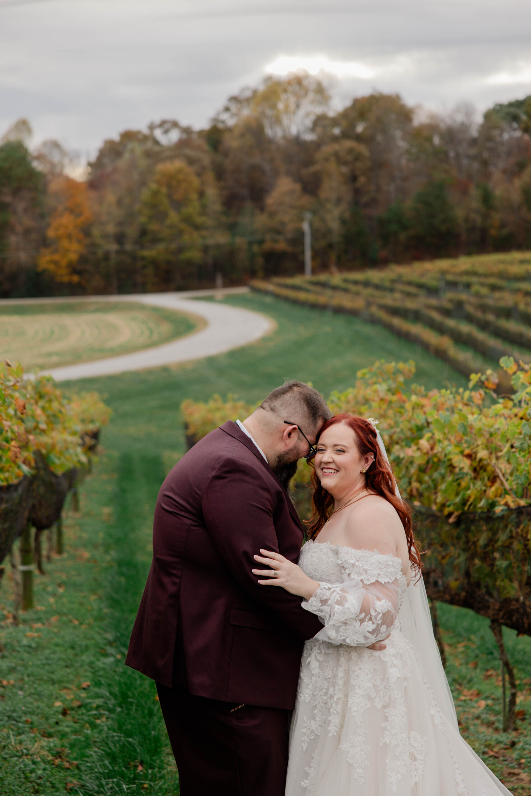 bride and groom share a loving moment in the vineyards