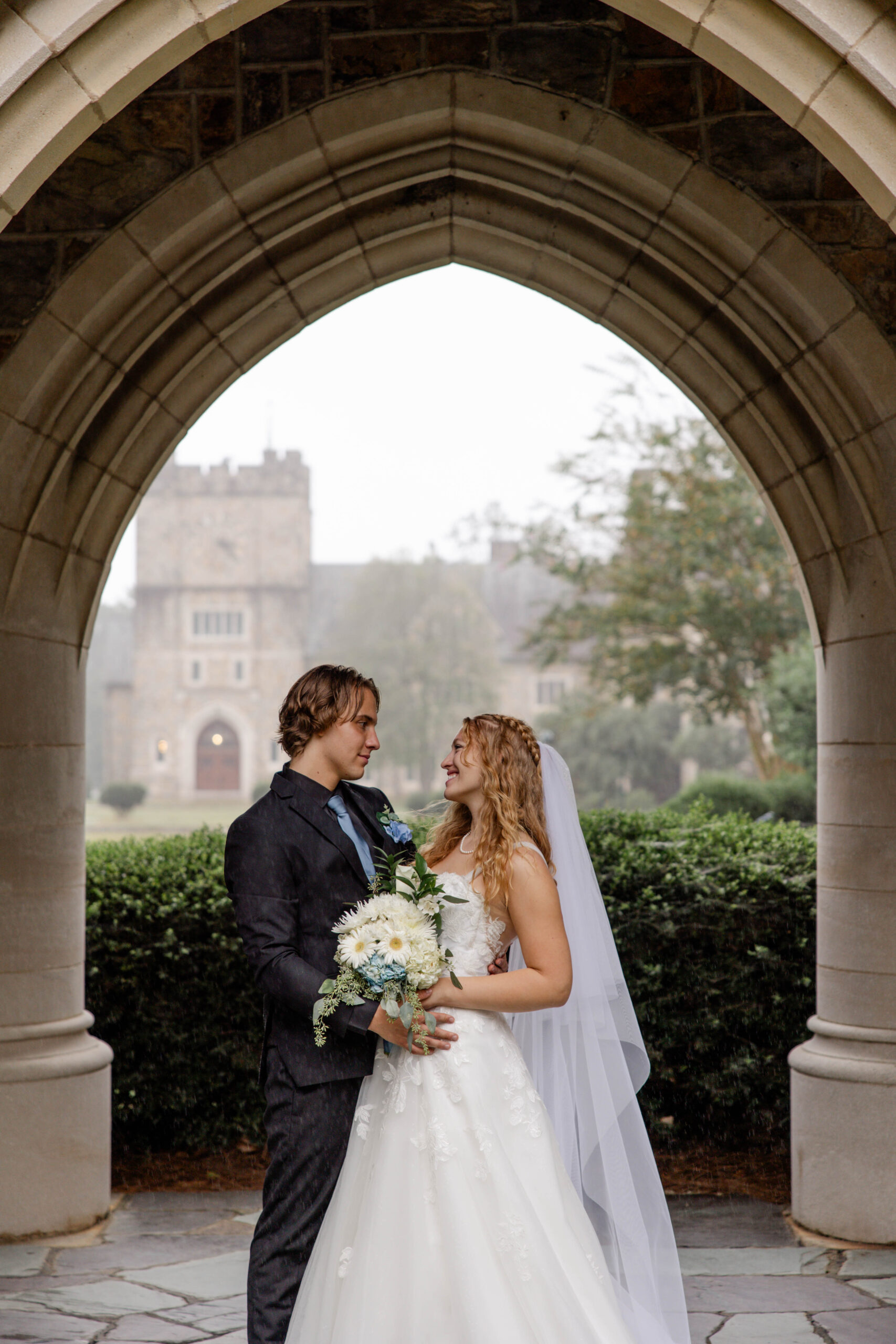 bride and groom share candid moments during their portraits