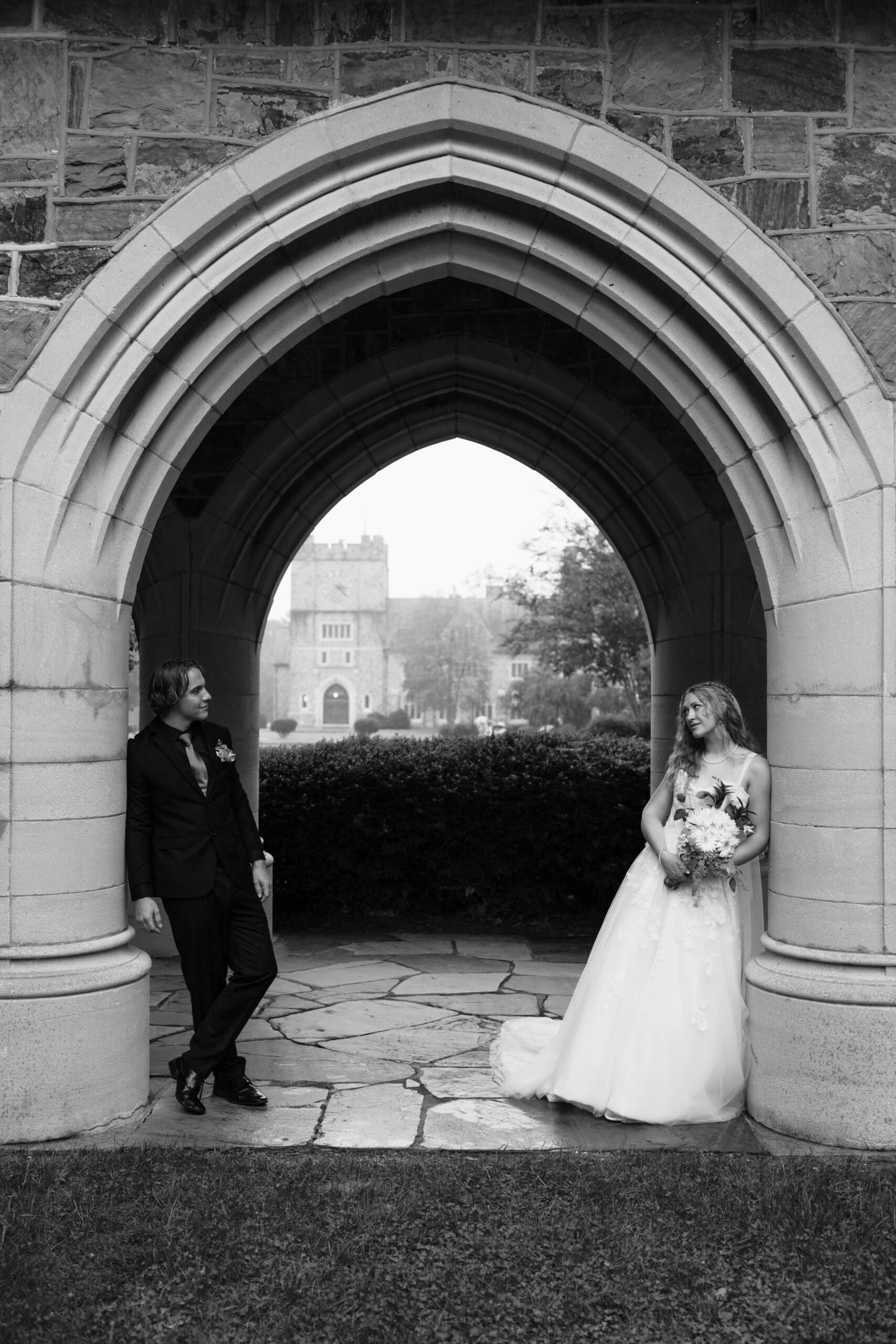 bride and groom pose together in an archway a great way to handle rain on your wedding day!
