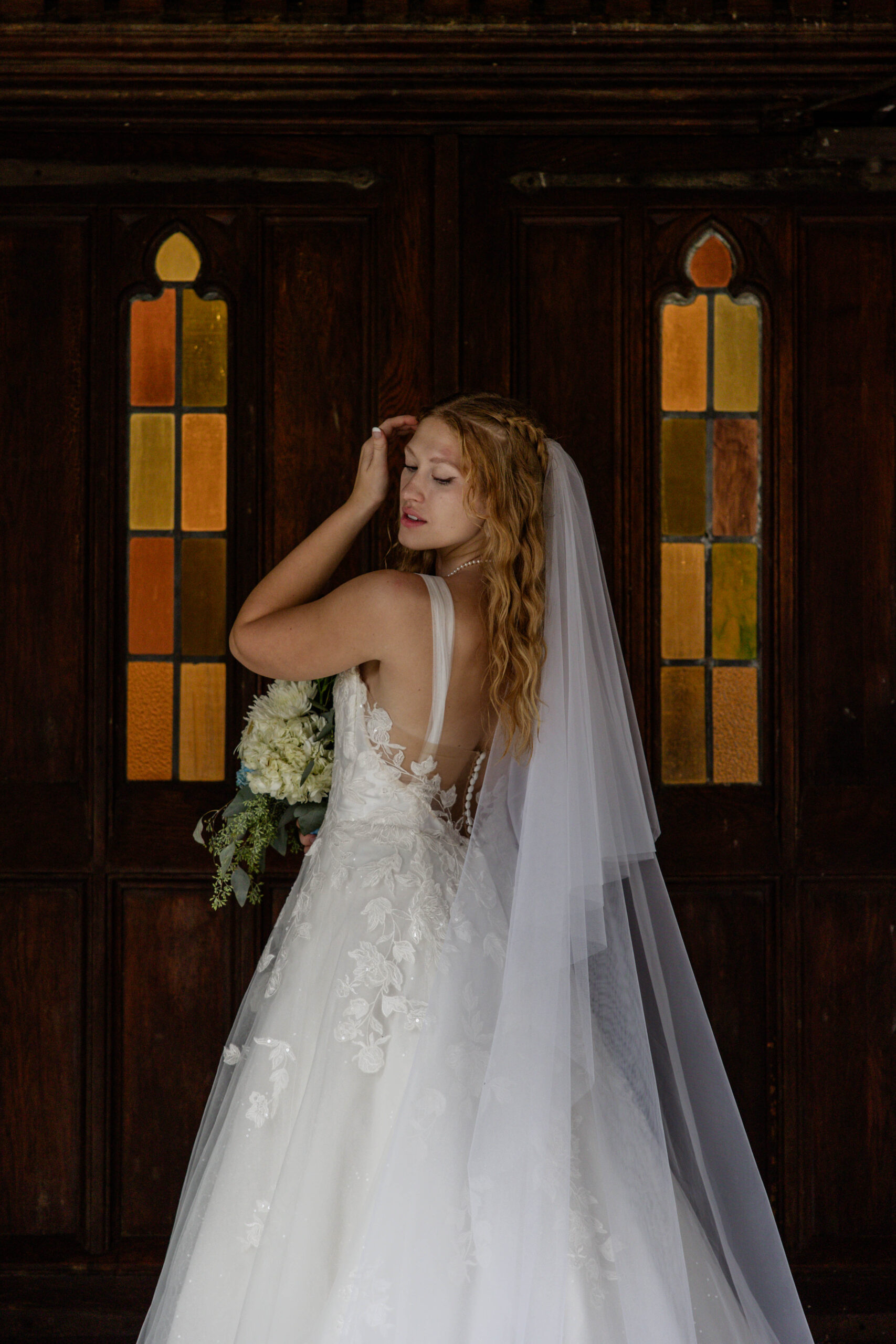 bride makes final adjustments to her hair as she handles rain on her wedding day