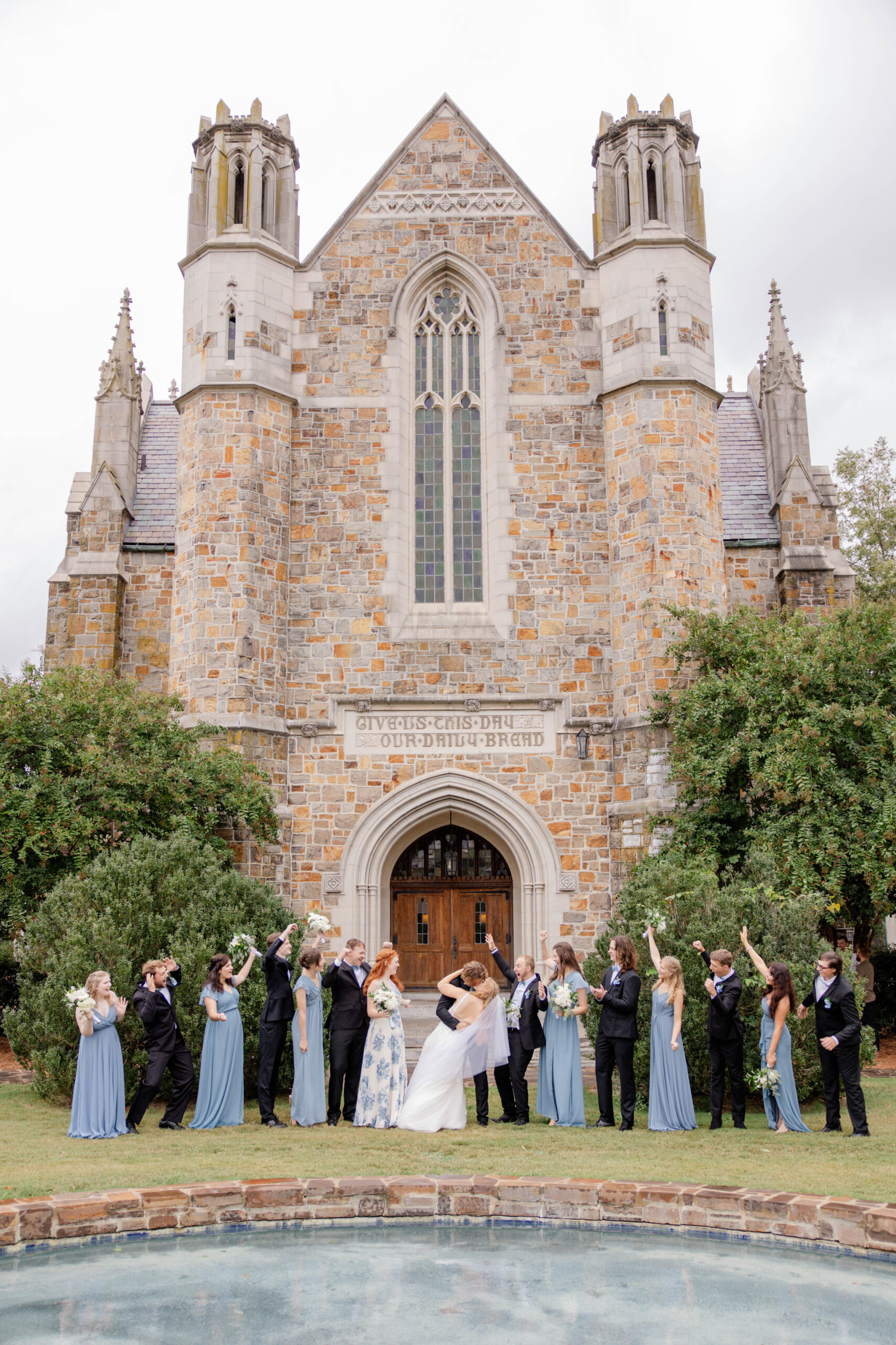 bride and groom share a kiss as the guests celebrate!