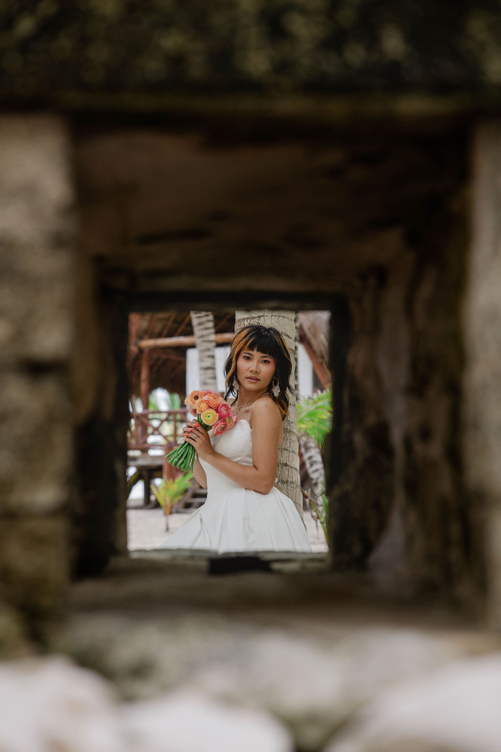 bride poses during the portraits at riviera maya wedding venue beach