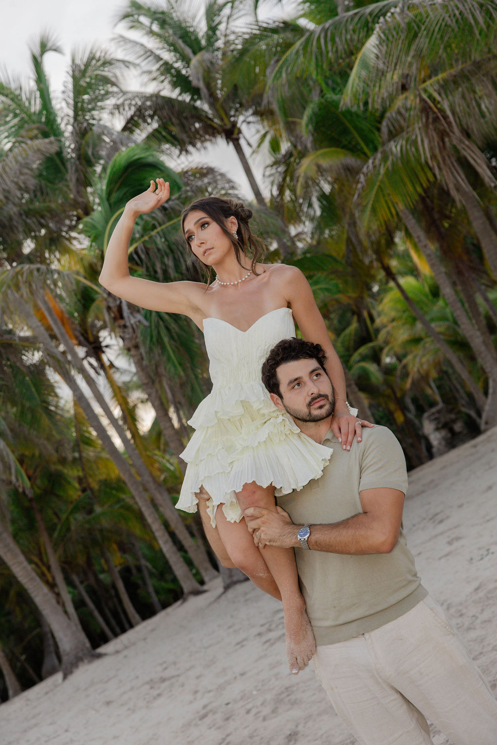 candid photos of the beautiful bride and groom as he carries away from the private beach