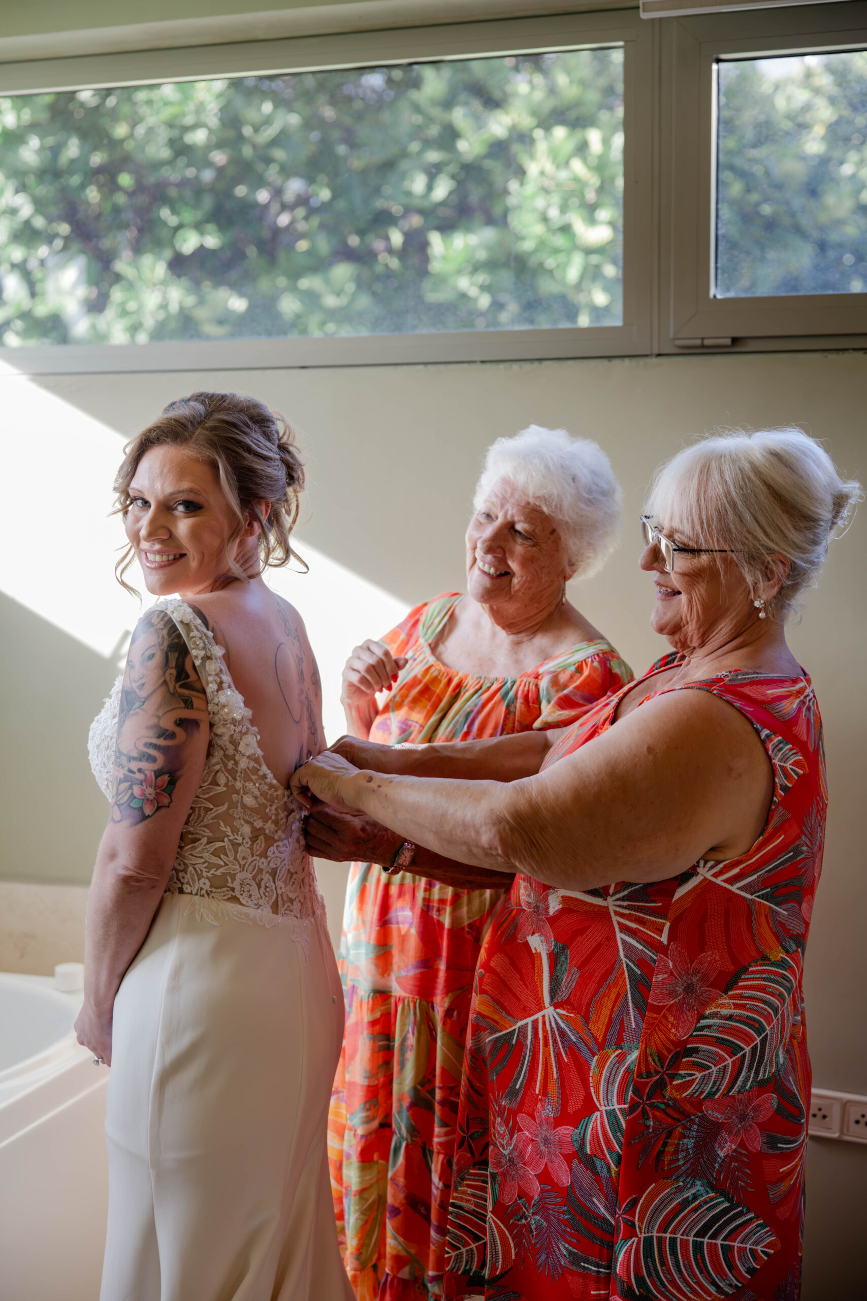 bride gets help with her wedding prep as she gets ready for her tropical wedding day