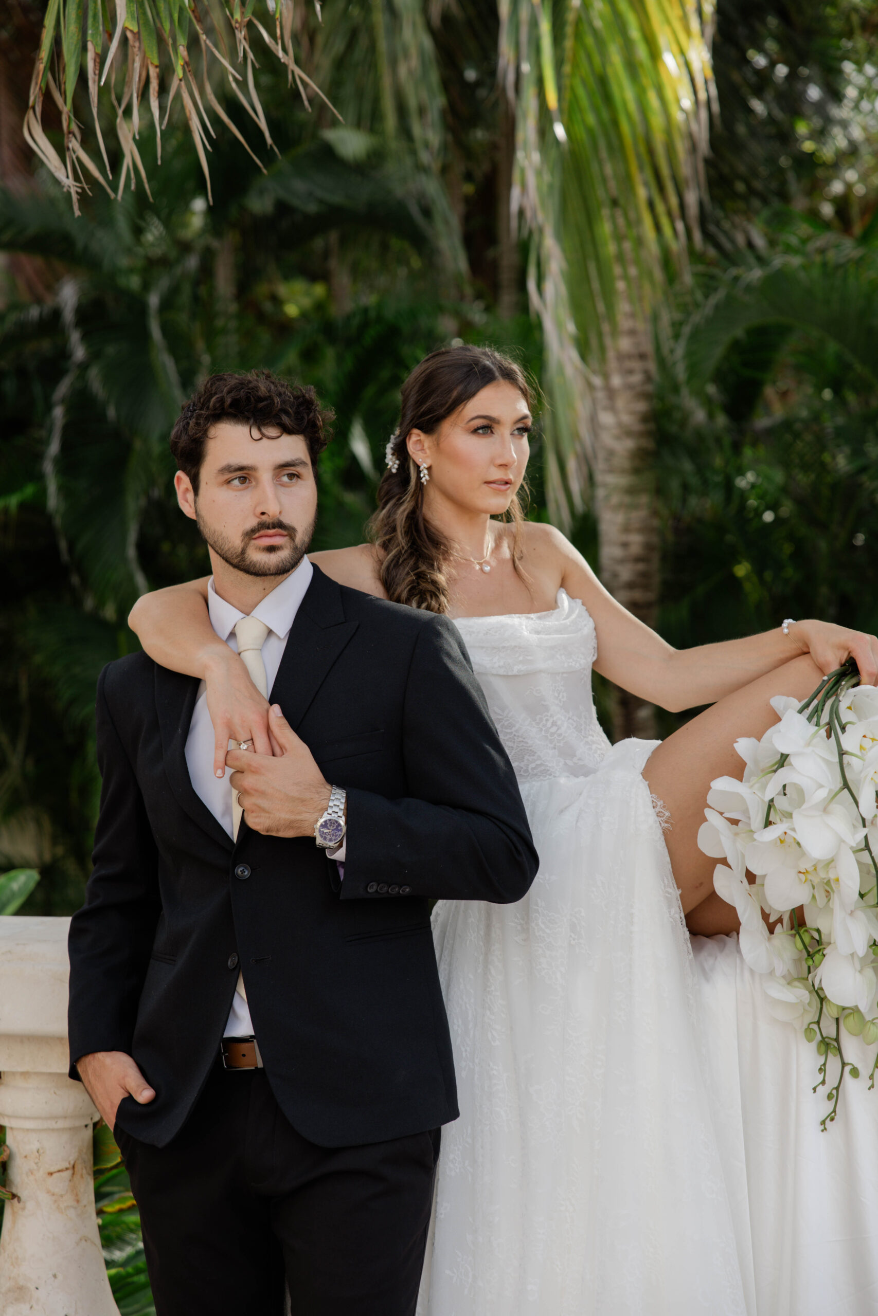 candid photo of a bride and groom outside the tropical wedding venue