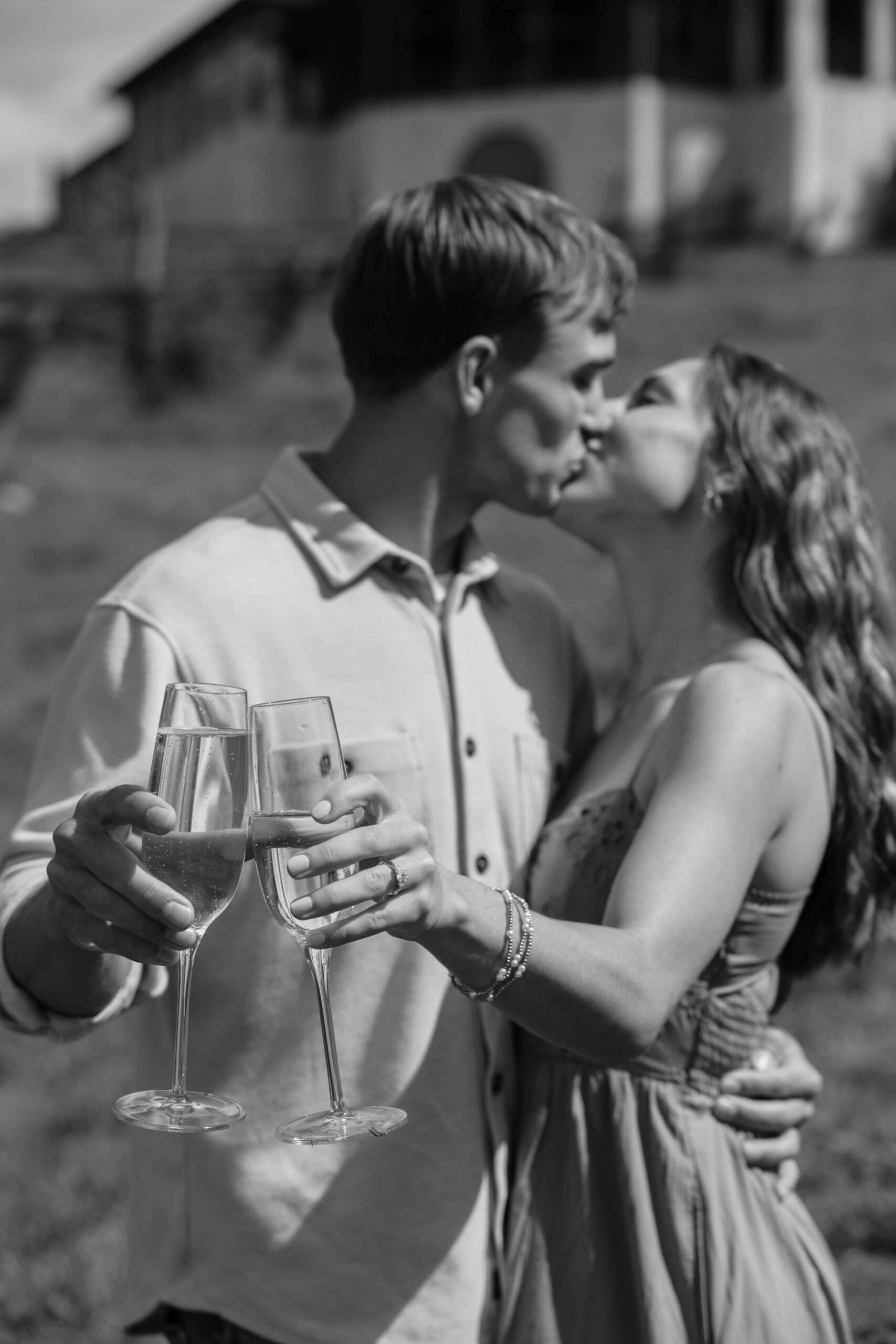 beautiful couple share a kiss in the winery