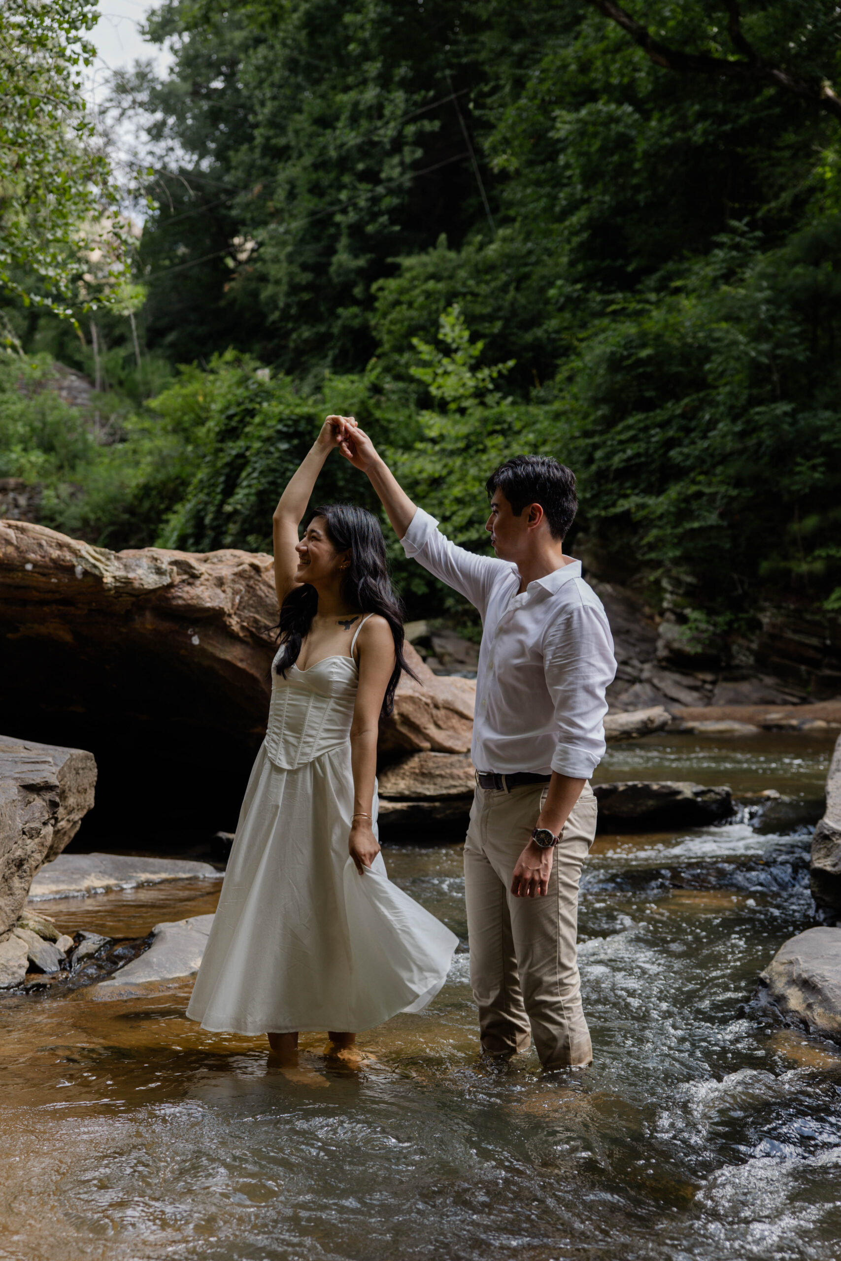 couple dance in the creek, a unique and natural way to capture engagement photos