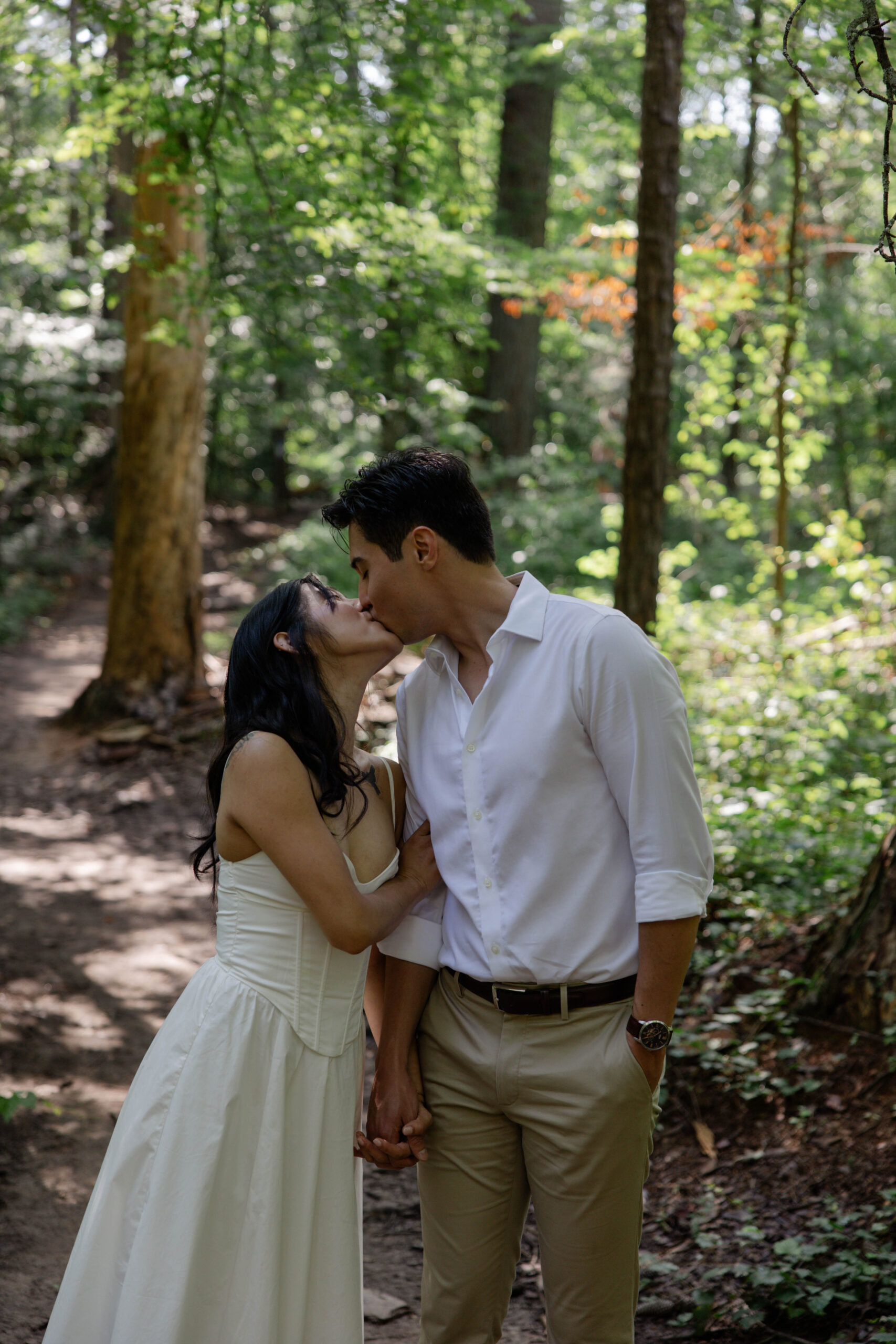 future bride and groom share a kiss while in the Georgia nature