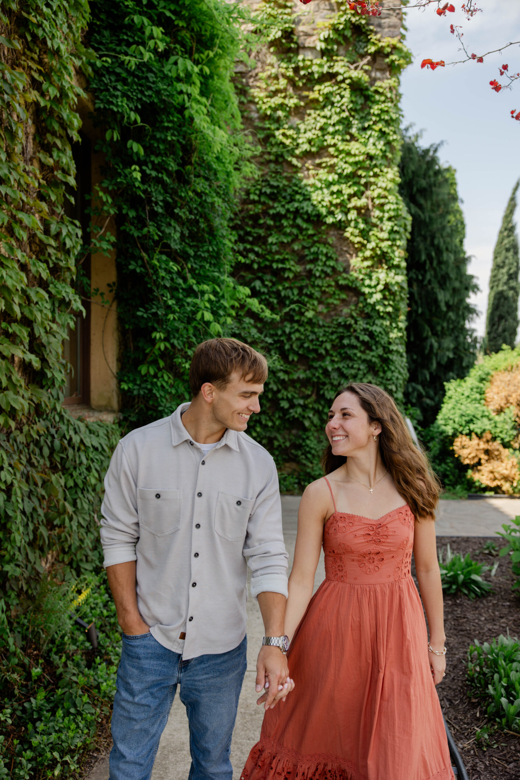 couple chat and laugh during their romantic engagement photoshoot