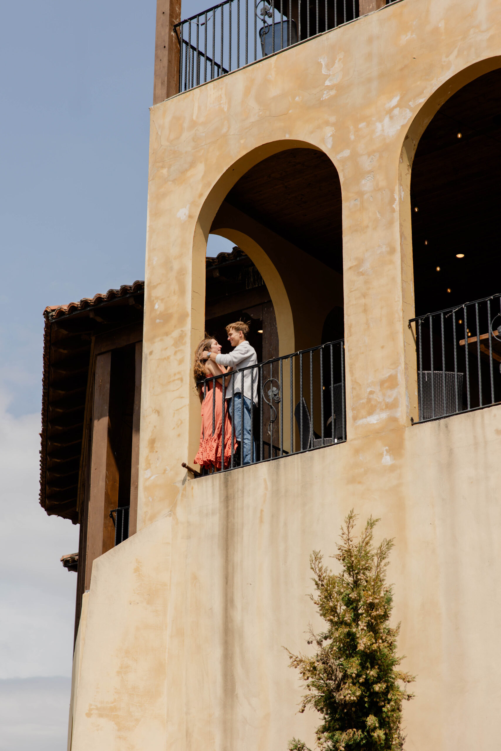 couple chat and laugh during their romantic engagement photoshoot