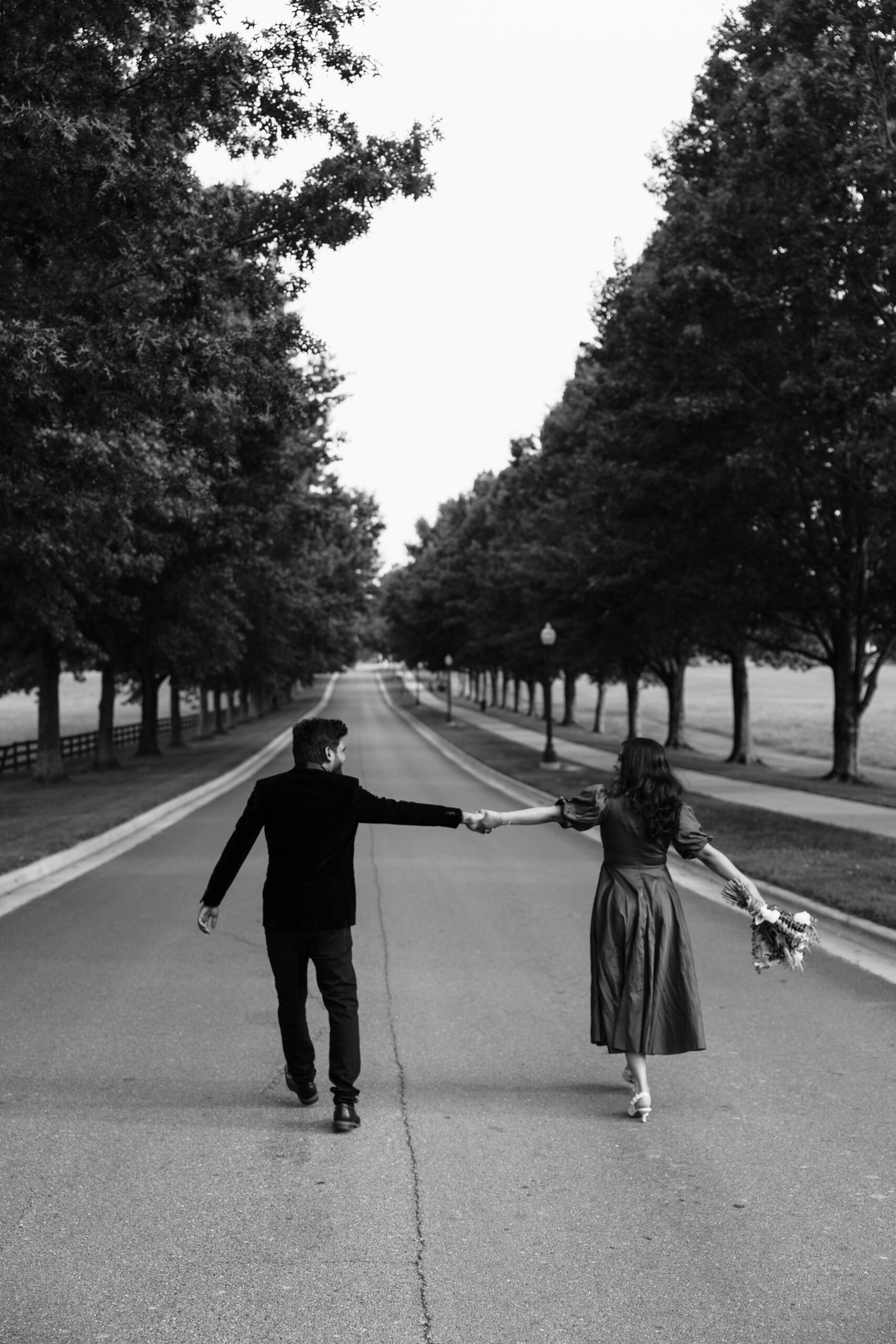 documentary style spring engagement photos captured by Keri L Photography as the stunning couple hold hands