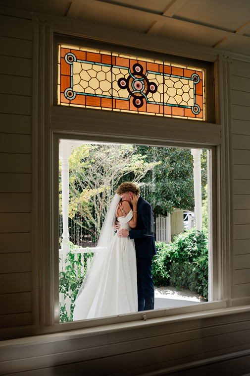 bride and groom share an intimate moment just outside the one of the top wedding venues in north georgia