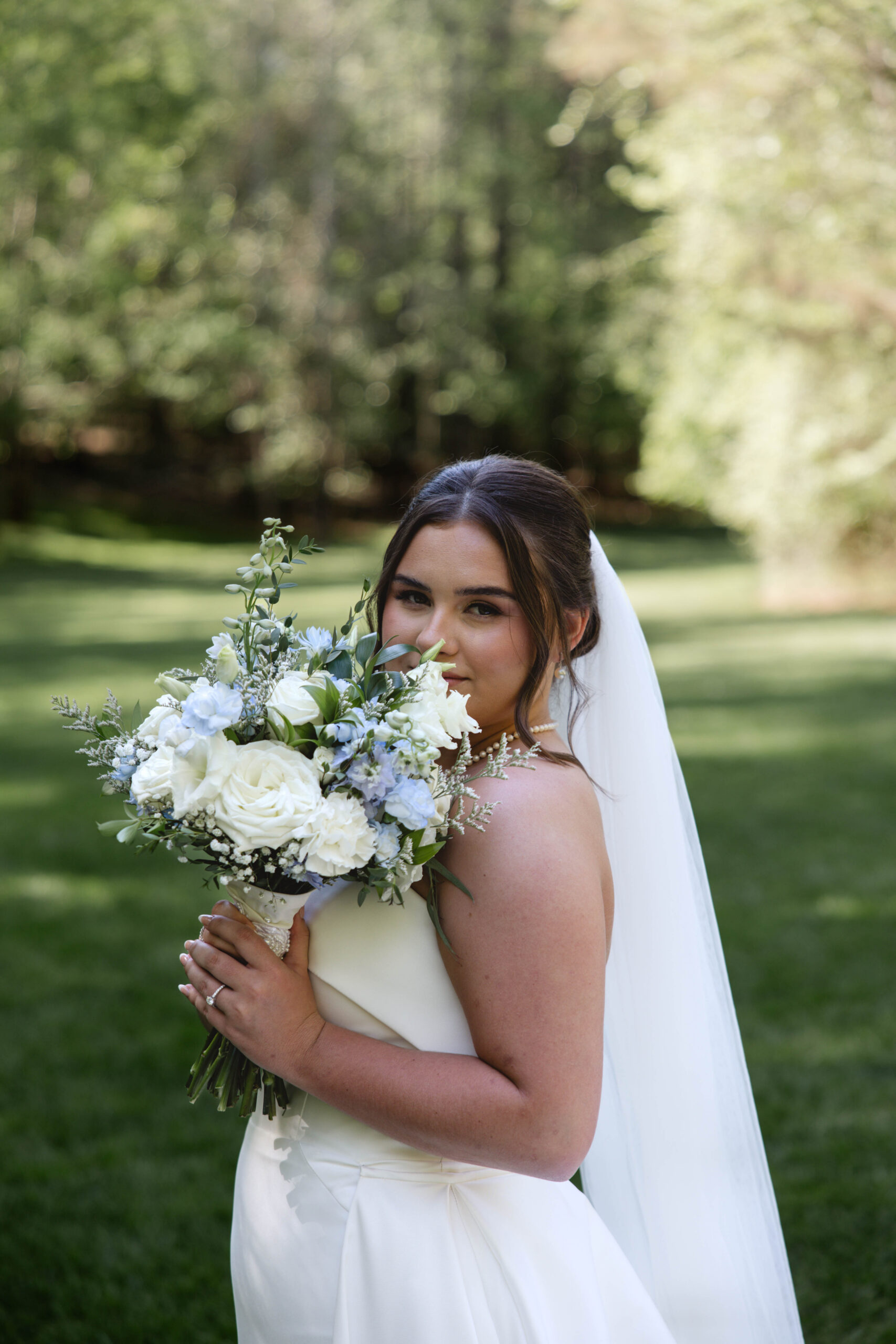 bride poses for a photo with her bouquet