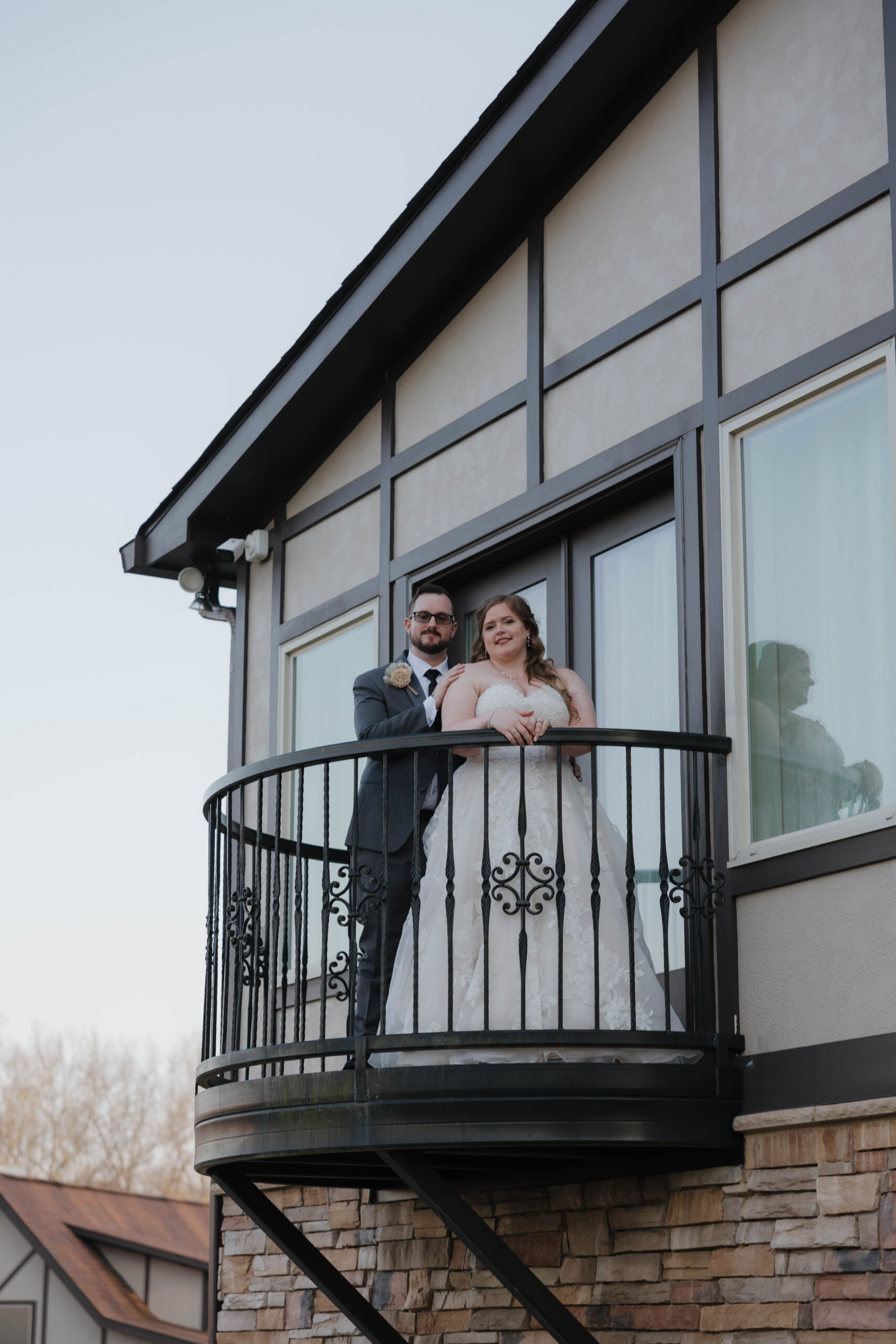 bride and groom pose for a photo on the patio at venue in the vines wedding day