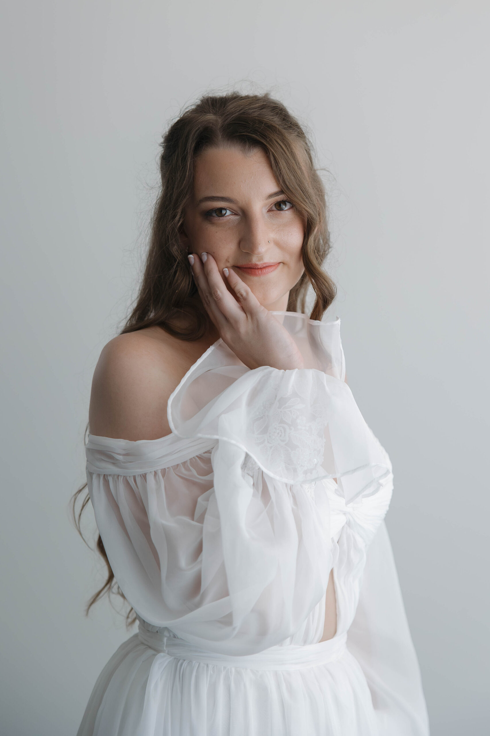 bride poses for a photo with a soft smile before her wedding at isla bella