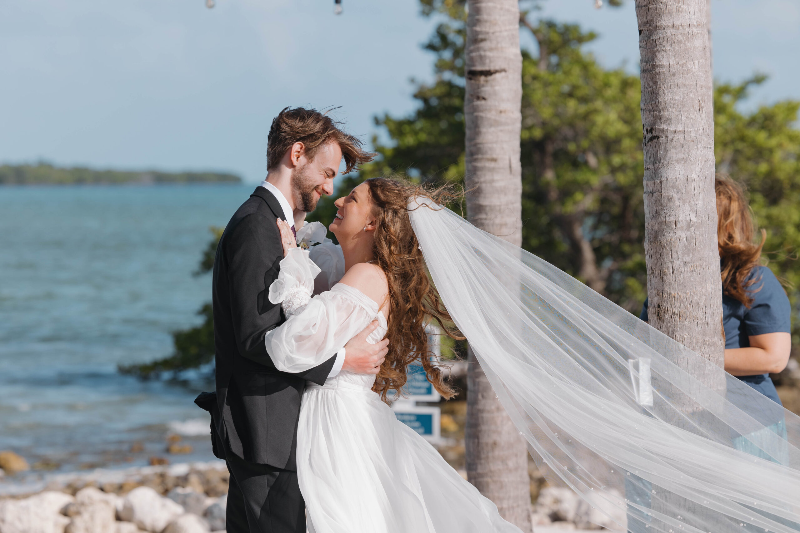 stunning bride and groom take a photo together during their Oceanfront wedding at isla bella