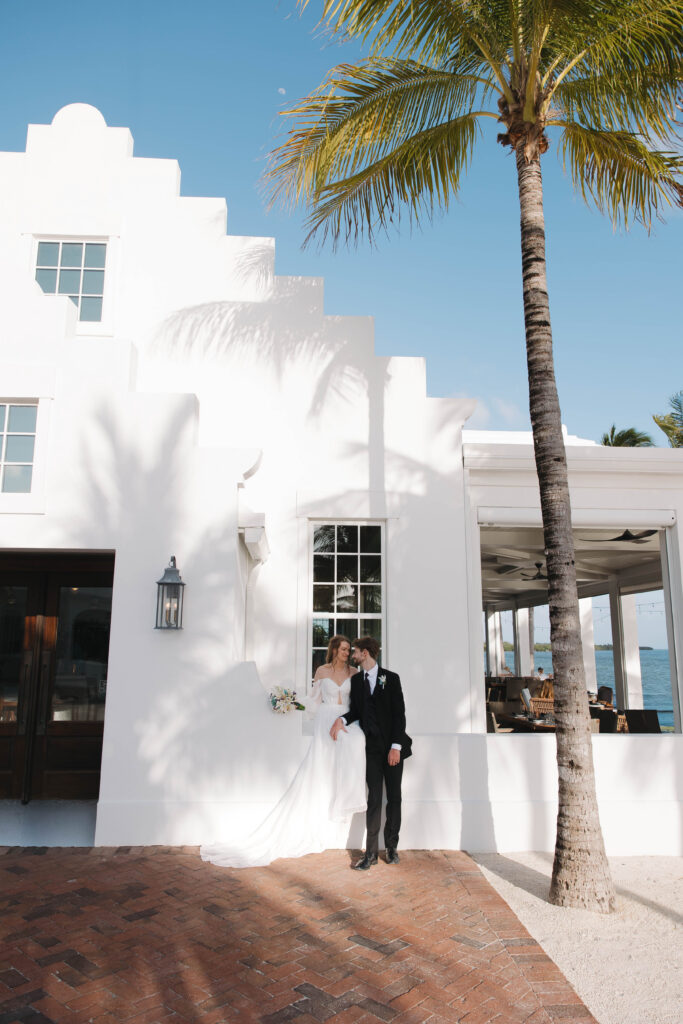 bride and groom pose for a photo on their wedding at isla bella