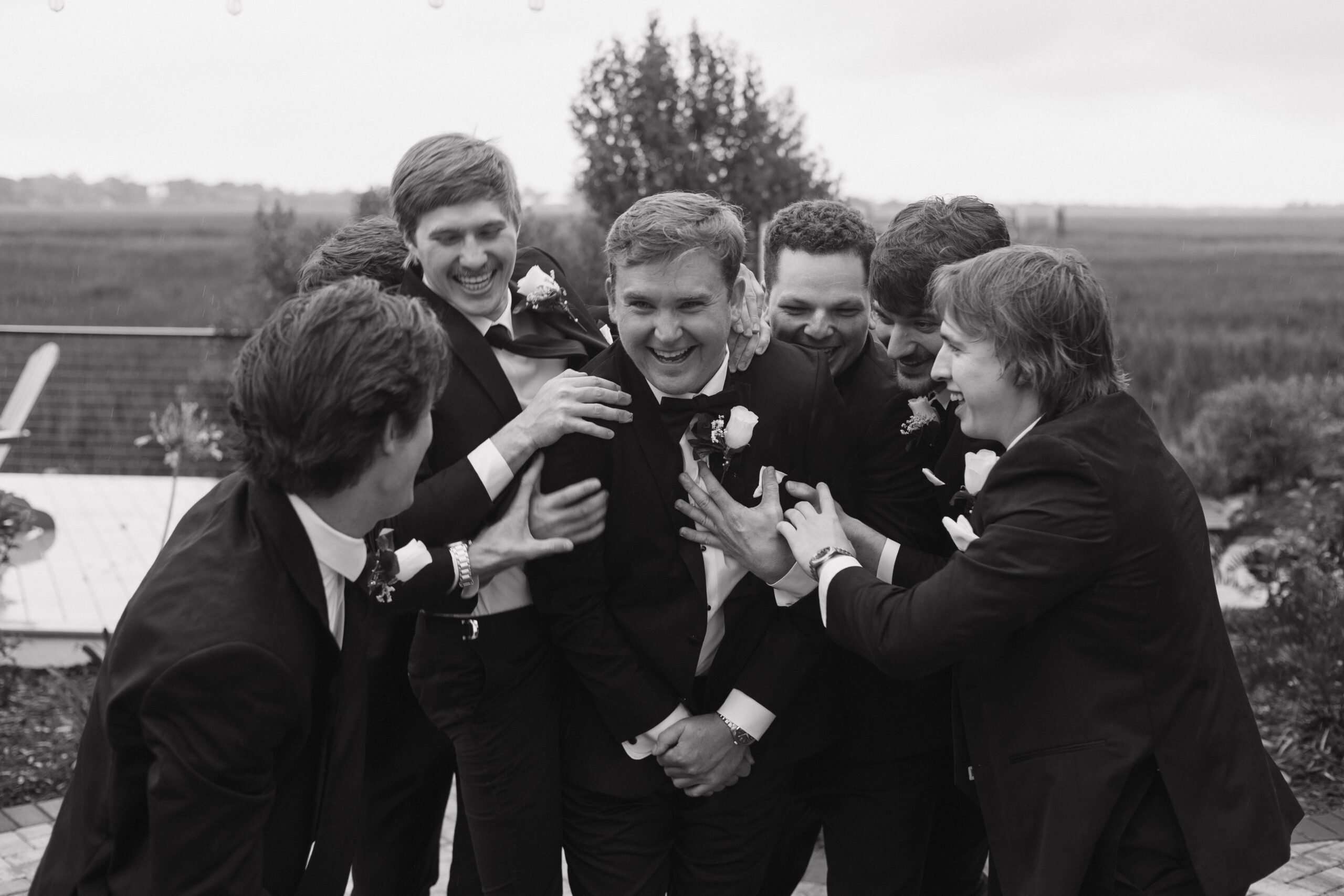 groomsmen pose for a photo with the groom ahead of the spring wedding day