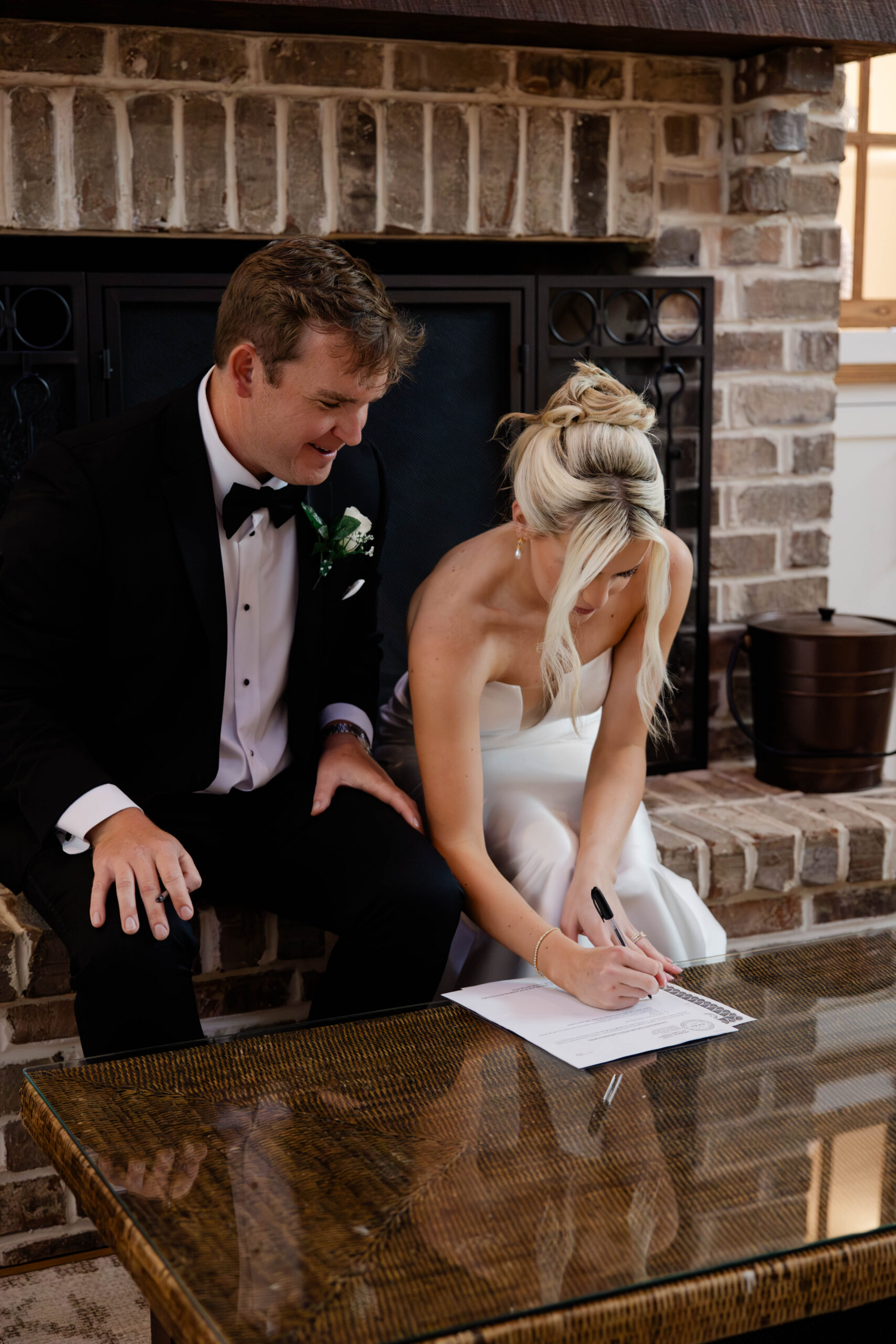 bride and groom sign their marriage license