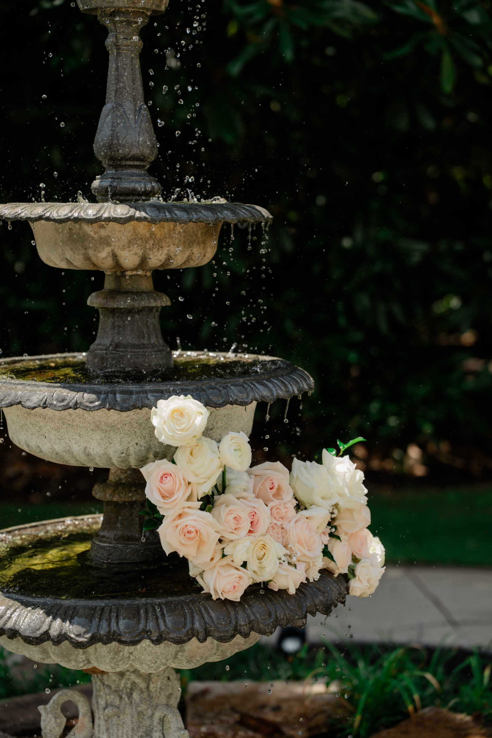 fountain at Wildflower 301 wedding venue flows over onto the stunning bridal bouquet