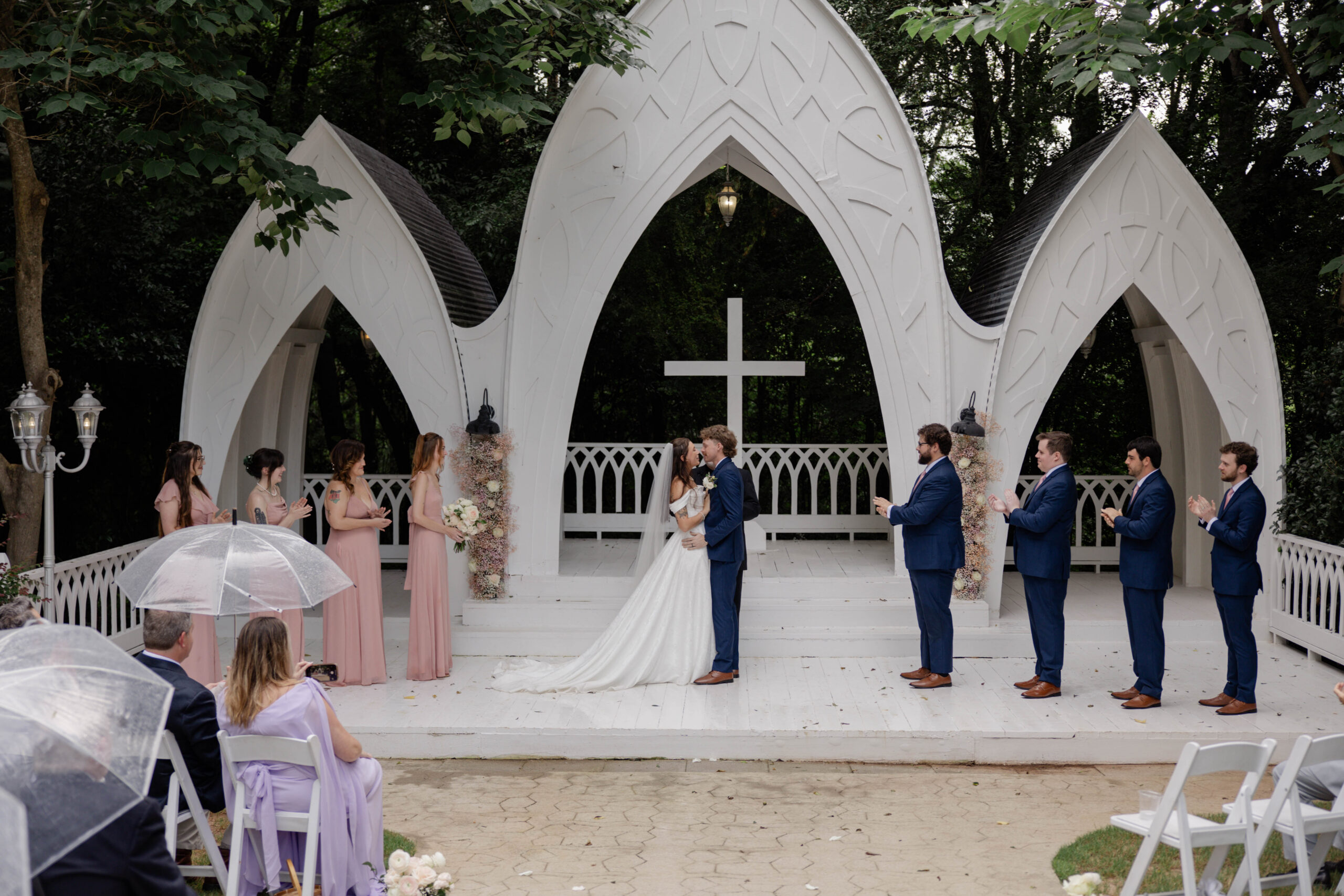 bride and groom share a kiss during their wedding ceremony at Wildflower 301 wedding venue