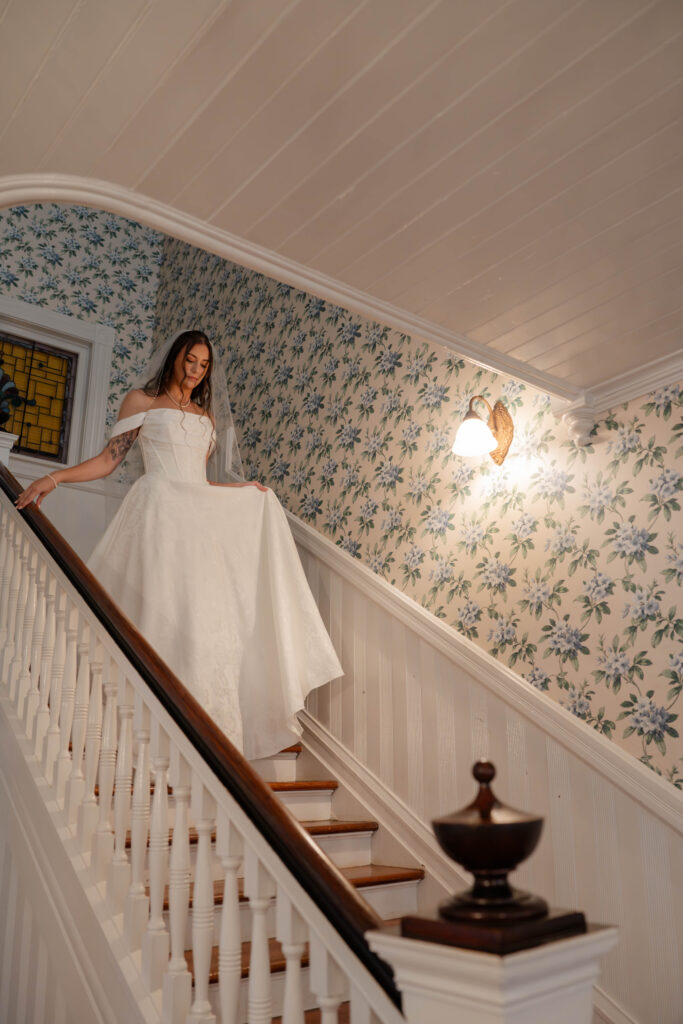 bride walks down the stairs at Wildflower 301 wedding venue