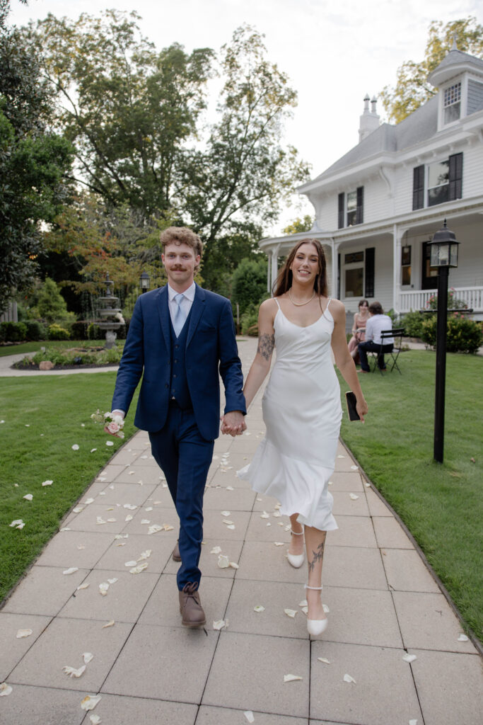 bride and groom walk away from their stunning wedding at Wildflower 301 wedding venue